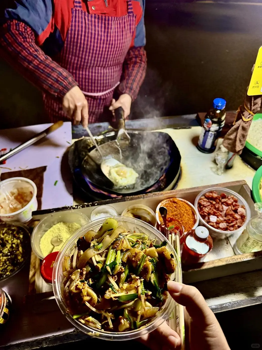 Fried noodles cooking in a wok at a late-night stall on Julu Road, Shanghai
