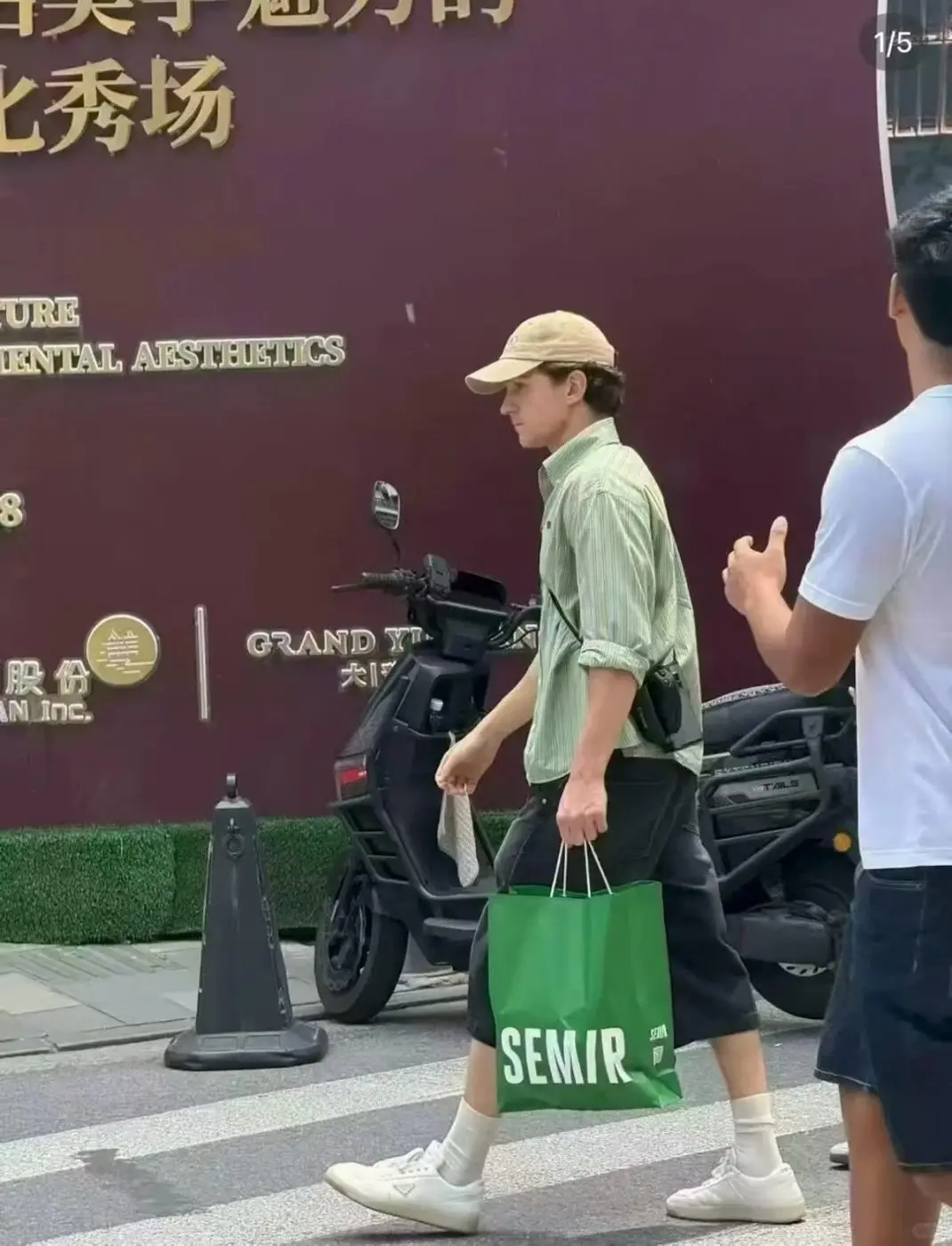 Tom Holland carrying a green Semir shopping bag in Shanghai